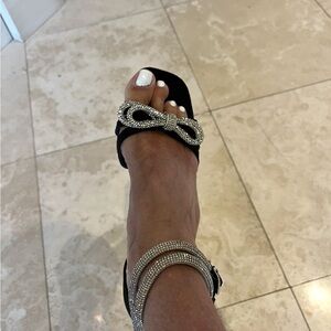 Brand new black suede heels with diamond bow and diamond ankle strap.